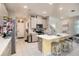 Modern kitchen with gray cabinets, an island, and a view of the living room at 1106 Rose Blossom Ct, Tampa, FL 33613