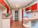 Retro kitchen boasts red cabinets, tiled counters, and wood floors at 114 Connie Ave, Tampa, FL 33613