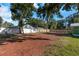 Large backyard with red mulch and partial fence at 1202 S Walker St, Plant City, FL 33563