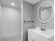 Updated bathroom with white vanity, toilet, and shower at 1202 S Walker St, Plant City, FL 33563