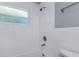 Updated bathroom with white subway tile, shower, and bathtub at 1202 S Walker St, Plant City, FL 33563