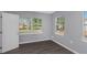 Well-lit bedroom with gray walls, wood-look floors, and windows at 1202 S Walker St, Plant City, FL 33563
