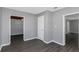 Gray-walled bedroom with wood-look floors and access to other rooms at 1202 S Walker St, Plant City, FL 33563