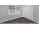 Spacious bedroom with gray walls, wood-look floors, and double doors at 1202 S Walker St, Plant City, FL 33563
