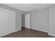 Bedroom with gray walls, wood-look floors, and white doors at 1202 S Walker St, Plant City, FL 33563