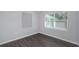 Bright bedroom with gray walls, wood-look floors, and window blinds at 1202 S Walker St, Plant City, FL 33563