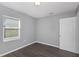 Cozy bedroom with grey walls and wood-look floors at 1202 S Walker St, Plant City, FL 33563