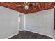 Bright bonus room features wood ceiling, gray walls, and dark laminate flooring at 1202 S Walker St, Plant City, FL 33563