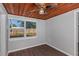 Bright bonus room features wood ceiling, gray walls, and dark laminate flooring at 1202 S Walker St, Plant City, FL 33563