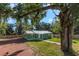 Charming green house with metal roof and spacious yard at 1202 S Walker St, Plant City, FL 33563