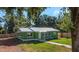 Newly renovated green house with metal roof and walkway at 1202 S Walker St, Plant City, FL 33563