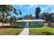 Newly renovated green house with metal roof and walkway at 1202 S Walker St, Plant City, FL 33563