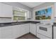 Renovated kitchen, white appliances and cabinets at 1202 S Walker St, Plant City, FL 33563