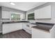 Bright kitchen with white cabinets, new appliances, and dark countertops at 1202 S Walker St, Plant City, FL 33563