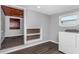 Laundry room with built-in shelving and adjacent bathroom at 1202 S Walker St, Plant City, FL 33563