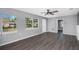 Open living area with gray walls, dark floors, and kitchen view at 1202 S Walker St, Plant City, FL 33563