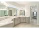 Elegant bathroom with double vanity, quartz countertop, and a walk-in shower at 12425 Glenridge Ln, Parrish, FL 34219