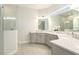 Elegant bathroom with double vanity, large mirror, and walk-in shower at 12425 Glenridge Ln, Parrish, FL 34219
