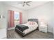 Cozy bedroom featuring a gray upholstered bed and pink accents at 12425 Glenridge Ln, Parrish, FL 34219