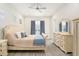 Main bedroom with large bed, dresser, and ceiling fan at 12425 Glenridge Ln, Parrish, FL 34219