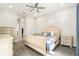 Light and airy bedroom with a large bed and access to the bathroom at 12425 Glenridge Ln, Parrish, FL 34219