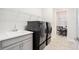 Convenient laundry room with washer, dryer, and utility sink at 12425 Glenridge Ln, Parrish, FL 34219