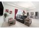 Spacious living room with leather sofa, wood accents, and a view of the pool at 12425 Glenridge Ln, Parrish, FL 34219