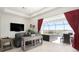 Living room with sliding doors that open onto a patio, pool, and lake view at 12425 Glenridge Ln, Parrish, FL 34219