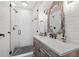 Modern bathroom with white subway tiles, a glass shower, and a wooden vanity at 1330 Snell Isle Ne Blvd # 4, St Petersburg, FL 33704