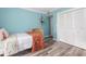 Second bedroom with light blue walls, wooden bed, and built-in closet at 1330 Snell Isle Ne Blvd # 4, St Petersburg, FL 33704