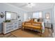 Main bedroom with light blue walls, wood flooring, and a rustic wooden bench at 1330 Snell Isle Ne Blvd # 4, St Petersburg, FL 33704