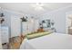 Main bedroom with light blue walls, wood flooring, and a rustic wooden bench at 1330 Snell Isle Ne Blvd # 4, St Petersburg, FL 33704