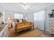 Main bedroom with light walls, wooden bed frame and a large window with curtains at 1330 Snell Isle Ne Blvd # 4, St Petersburg, FL 33704