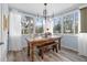 Bright dining room with farmhouse table and chandelier, offering ample natural light at 1330 Snell Isle Ne Blvd # 4, St Petersburg, FL 33704