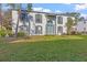 Two-story white brick building with green door, landscaping, and grassy yard at 1330 Snell Isle Ne Blvd # 4, St Petersburg, FL 33704