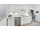 Modern kitchen with white cabinets, granite countertops and stainless steel appliances at 1330 Snell Isle Ne Blvd # 4, St Petersburg, FL 33704