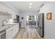 Modern kitchen with white cabinets, granite countertops, and stainless steel appliances at 1330 Snell Isle Ne Blvd # 4, St Petersburg, FL 33704