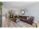 Spacious living room with hardwood floors, leather couch, and a view into the dining area at 1330 Snell Isle Ne Blvd # 4, St Petersburg, FL 33704