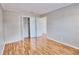 Bedroom with wood-look floors, white closet doors and access to another room at 13760 Orange Sunset Dr # 201, Tampa, FL 33618