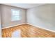 Bedroom with wood-look floors and a window at 13760 Orange Sunset Dr # 201, Tampa, FL 33618
