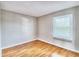 Bright bedroom with wood flooring and a window at 13760 Orange Sunset Dr # 201, Tampa, FL 33618