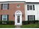 Brick building exterior with a white door entrance, landscaping, and address number at 13760 Orange Sunset Dr # 201, Tampa, FL 33618