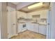 White kitchen with white cabinets, tiled floors and appliances at 13760 Orange Sunset Dr # 201, Tampa, FL 33618