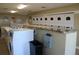 Well-lit laundry room with multiple washers and dryers at 13760 Orange Sunset Dr # 201, Tampa, FL 33618