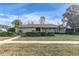 Single-story home with a well-maintained lawn and landscaping at 14022 Passage Way, Seminole, FL 33776