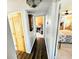 Bright hallway with dark wood floors and access to bedrooms at 1410 Bass Blvd, Dunedin, FL 34698