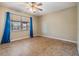 Bedroom with tile flooring, ceiling fan, and blue curtains at 1417 Windjammer Loop, Lutz, FL 33559