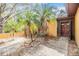 Home entrance with double doors and palm trees at 1417 Windjammer Loop, Lutz, FL 33559