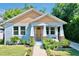 Charming craftsman style home with light blue siding and a welcoming front porch at 1518 E North St, Tampa, FL 33610