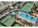 An aerial shot showcases the community tennis courts, basketball court, and pool at 1520 Gulf Blvd # 1602, Clearwater Beach, FL 33767